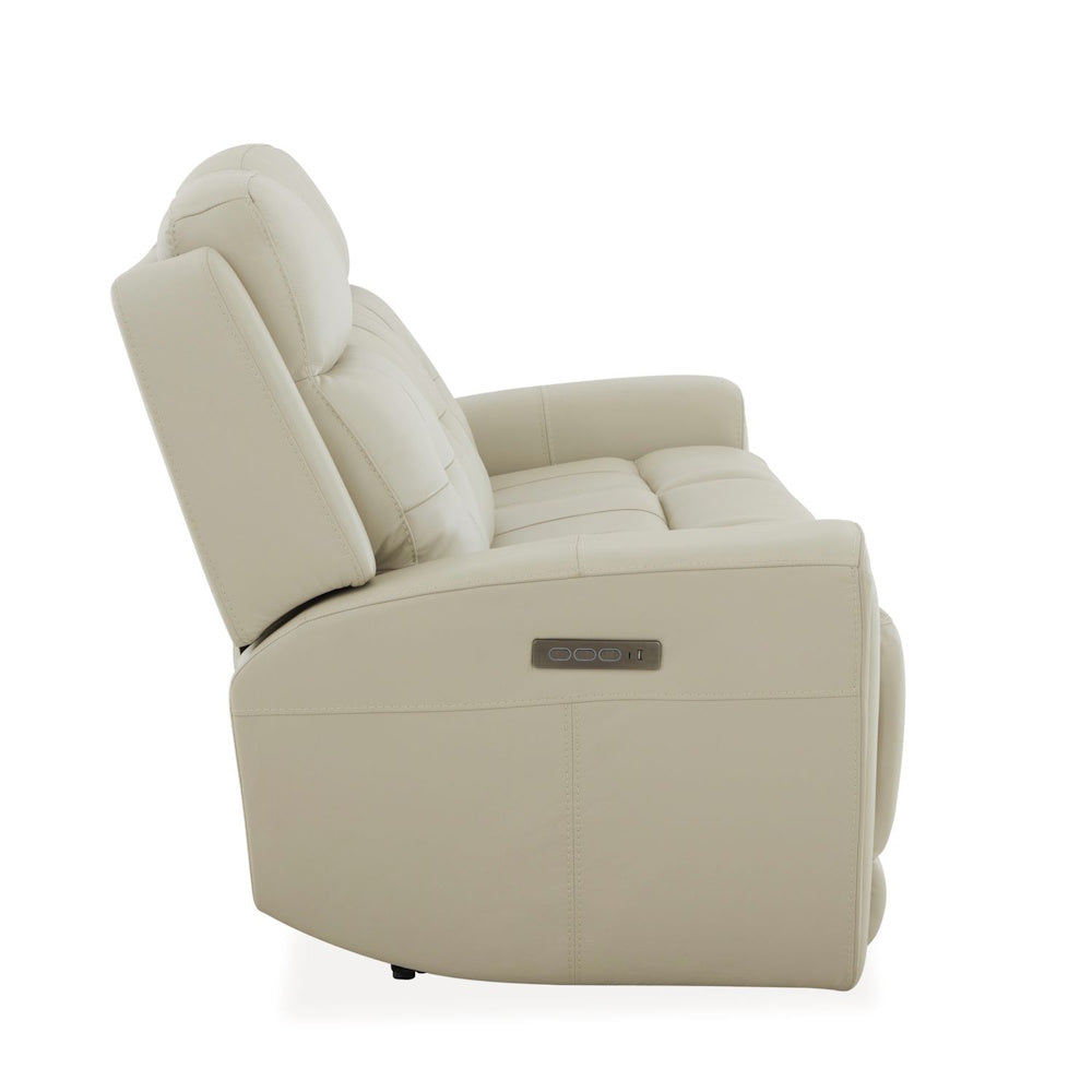 Side view of cream leather power reclining sofa with adjustable headrest, padded seating and built in controls.