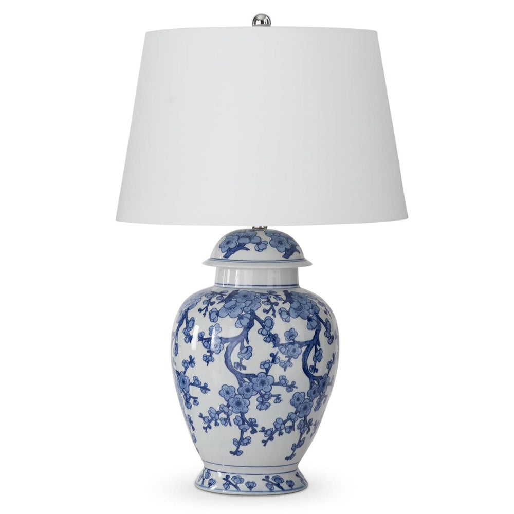 Blue and white ceramic ginger jar table lamp with floral cherry blossom pattern and white drum shade.