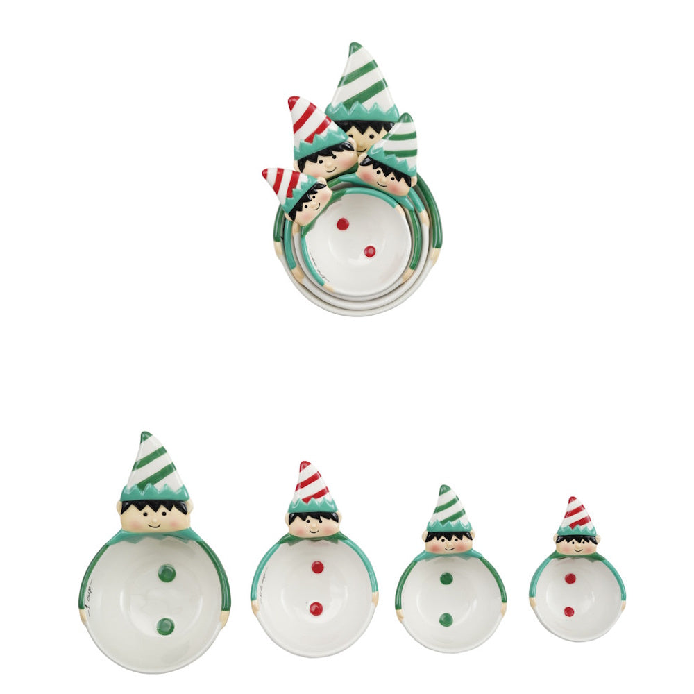Four ceramic measuring cups shaped like holiday elves with striped hats, displayed nested and lined up.