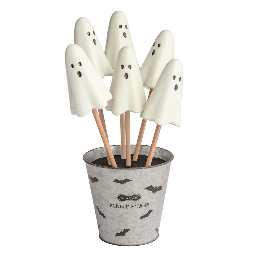 Mud Pie ceramic ghost plant stakes with wooden dowels arranged in a galvanized metal bat-patterned bucket.