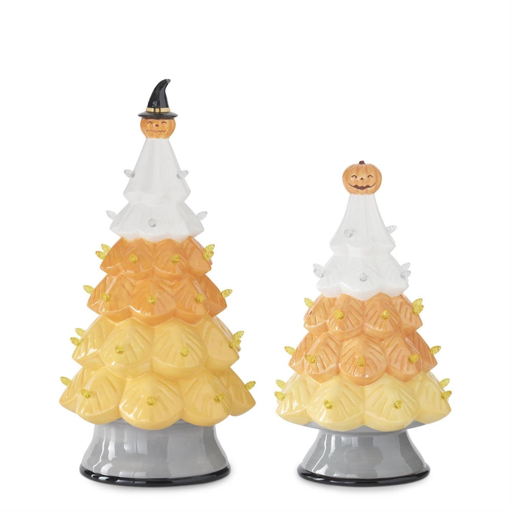 Two ceramic candy corn Halloween trees with small lights, topped with a witch pumpkin and a regular pumpkin.
