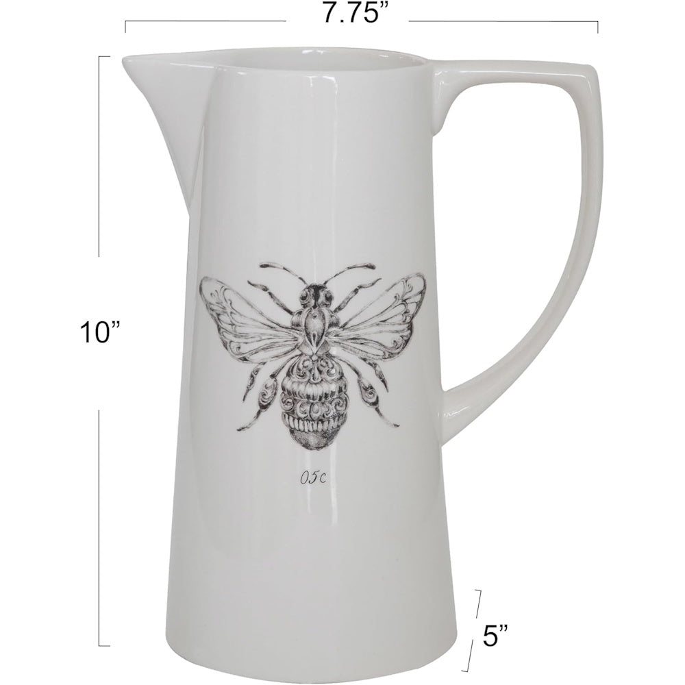 A white ceramic pitcher featuring a detailed black bee illustration, labeled with product dimensions.