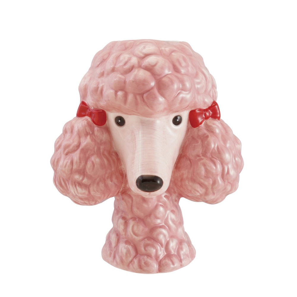 Pink ceramic poodle head-shaped vase with red bows in its fur on a white background.