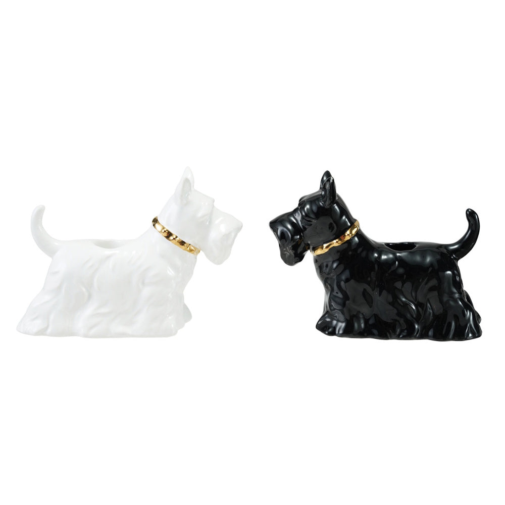 Black and white ceramic Scottie dog taper candle holders with gold collars.