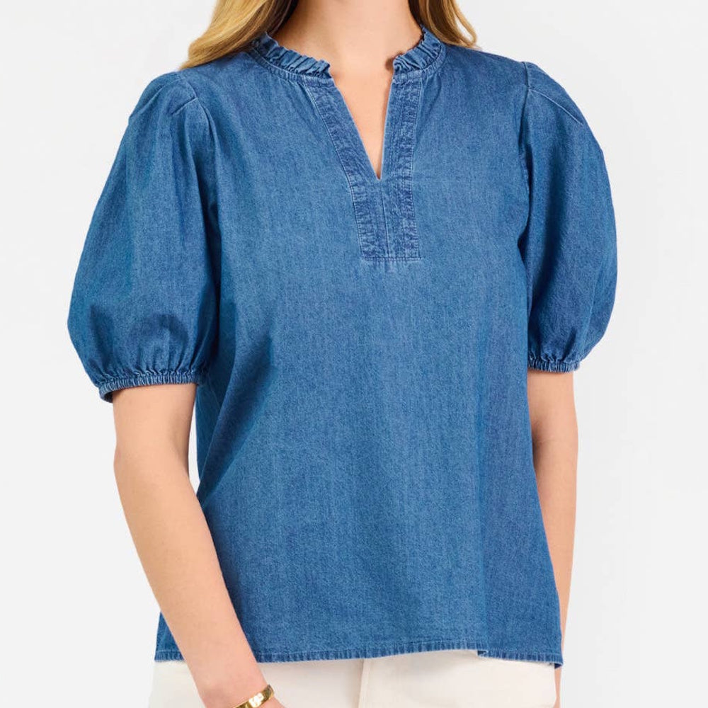 Blue chambray v-neck blouse with short puff sleeves and a ruffled collar.