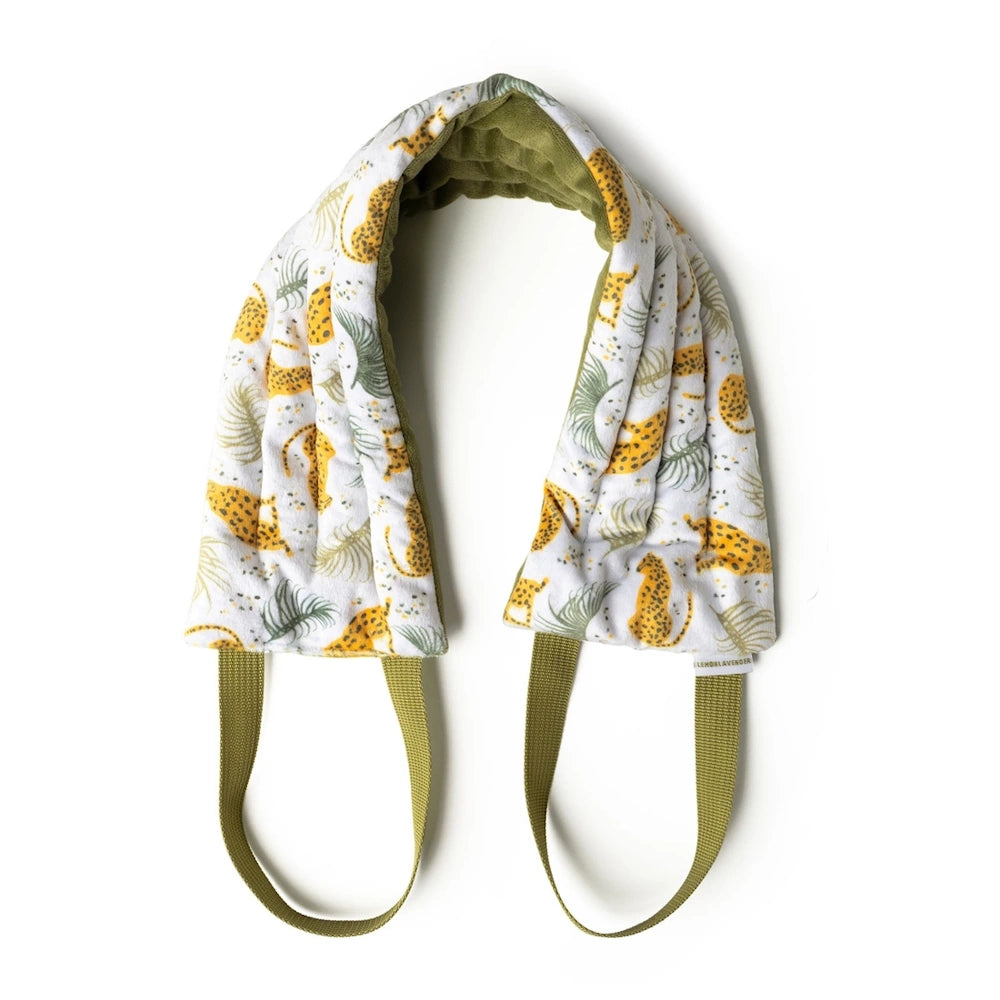Leopard and palm leaf print heated neck wrap with olive green lining and straps on a white background.