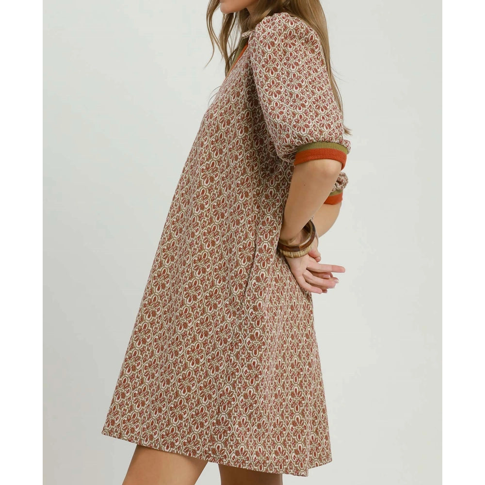 Side view of a woman wearing a chestnut pattern shift dress with short puffed sleeves.