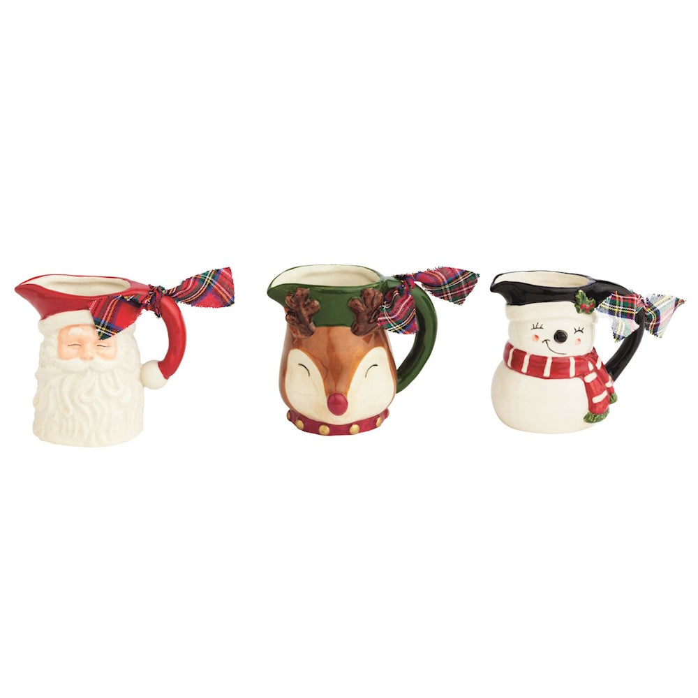 Three ceramic Christmas pitcher vases shaped like Santa, a reindeer, and a snowman with plaid bows.
