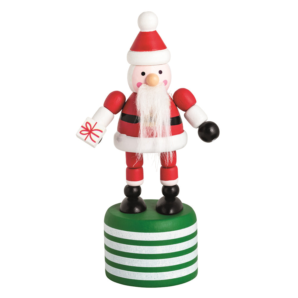 Wooden Santa Claus thumb press toy on a green striped base, holding a small gift box.