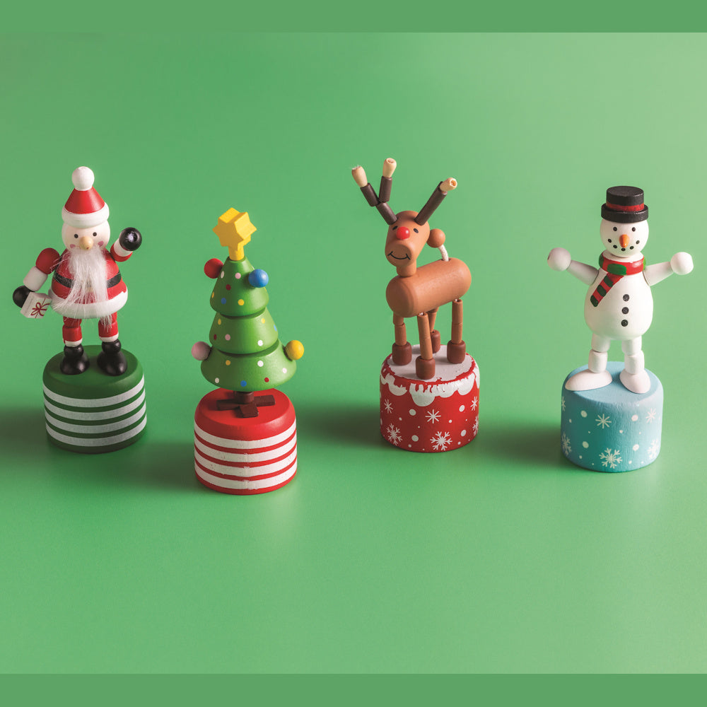 Four wooden Christmas push-button toys: Santa, a Christmas tree, a reindeer, and a snowman on colorful pedestal bases.