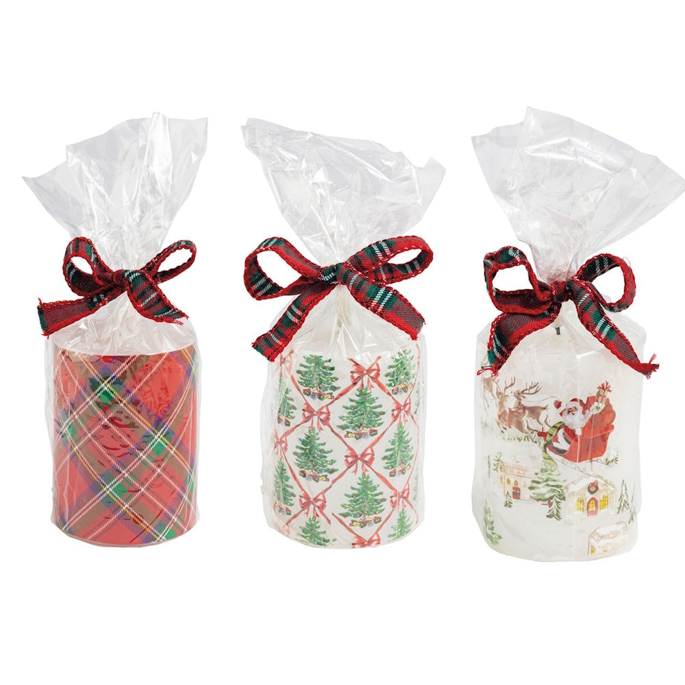 Three Christmas flameless pillar candles wrapped in clear plastic with red plaid bows shown from the front.