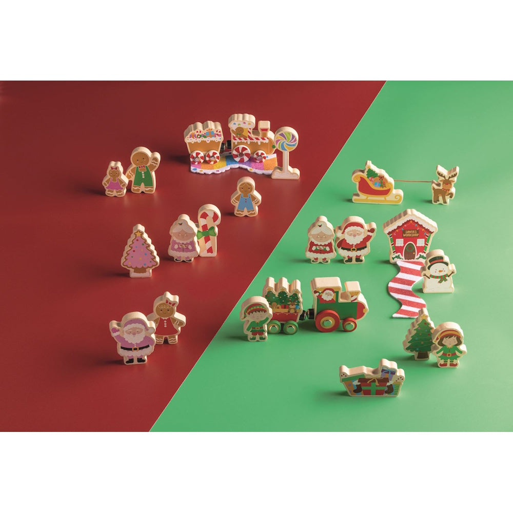 Christmas wooden toy set featuring festive figures, trains, and trees on red and green surfaces.