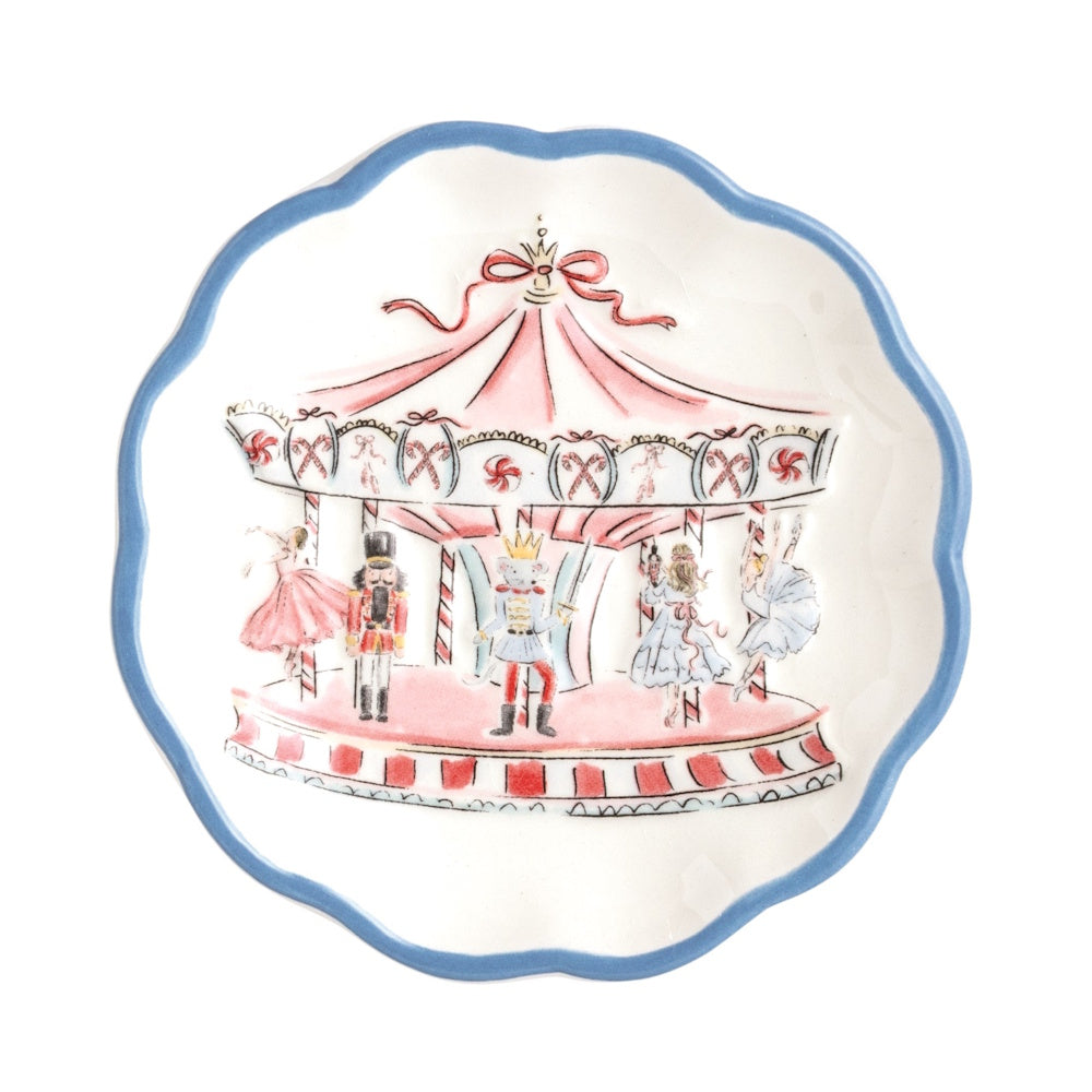 Scalloped white tidbit plate featuring a pink winter wonderland carousel design with nutcrackers and dancers.