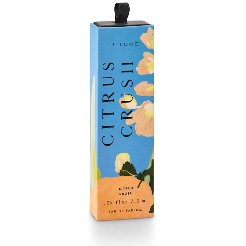 A blue box of Illume Citrus Crush Eau de Parfum with floral illustrations and a black loop on top.