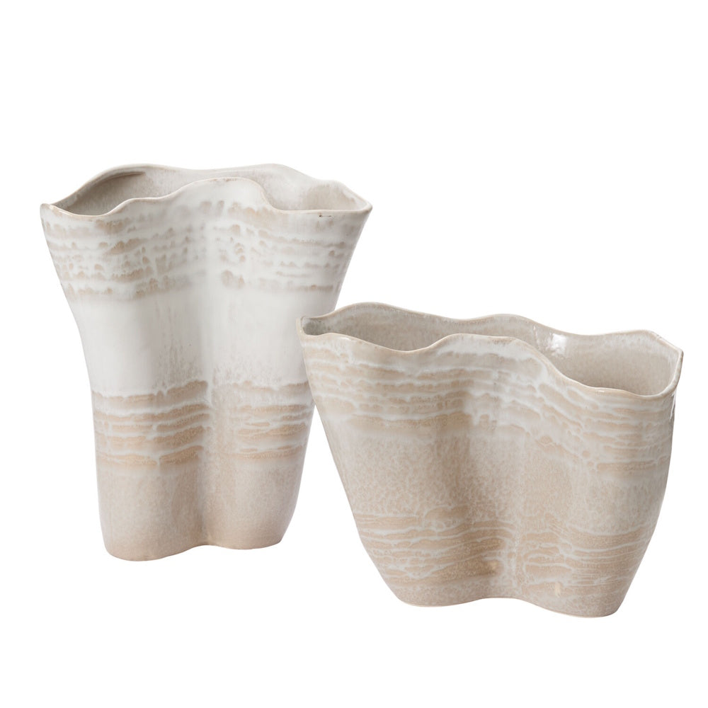 Two wavy ceramic vases in beige and white with textured, layered horizontal stripes against a plain background.