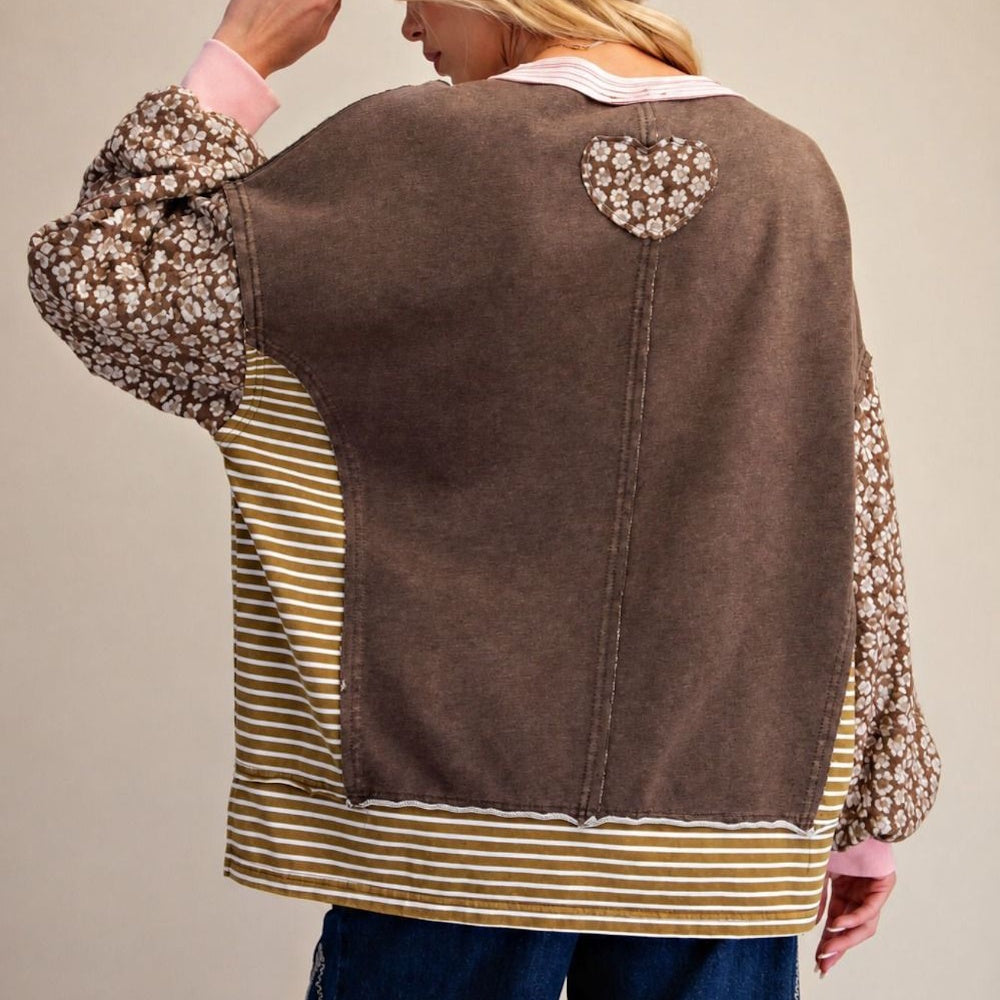 Back view of coffee brown terry knit pullover with floral sleeves, striped panels, and floral heart patch.