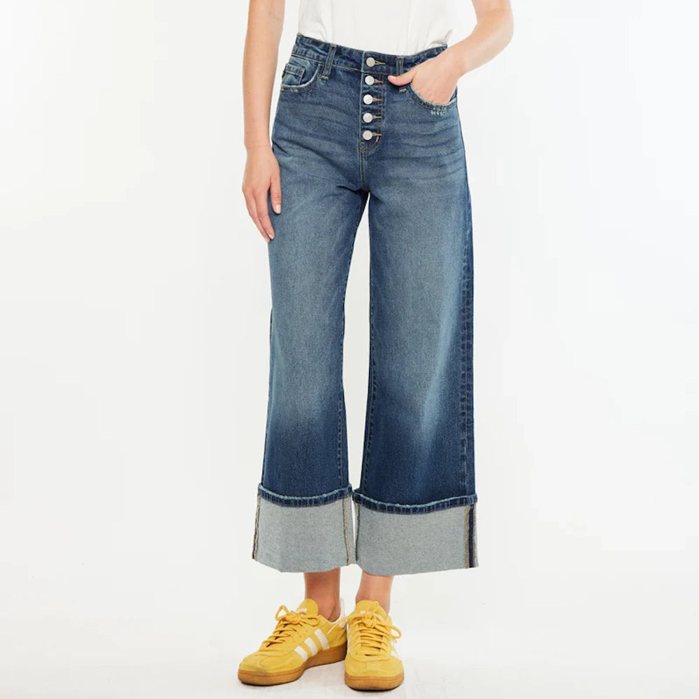 Ultra high-rise wide-leg cropped jeans with a button fly and wide cuffed hems, paired with yellow sneakers.