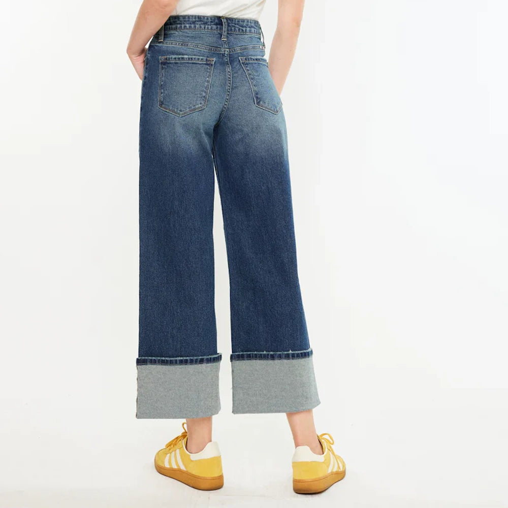Ultra high-rise wide-leg cropped jeans in dark wash blue with large folded cuffs and back pocket detail.