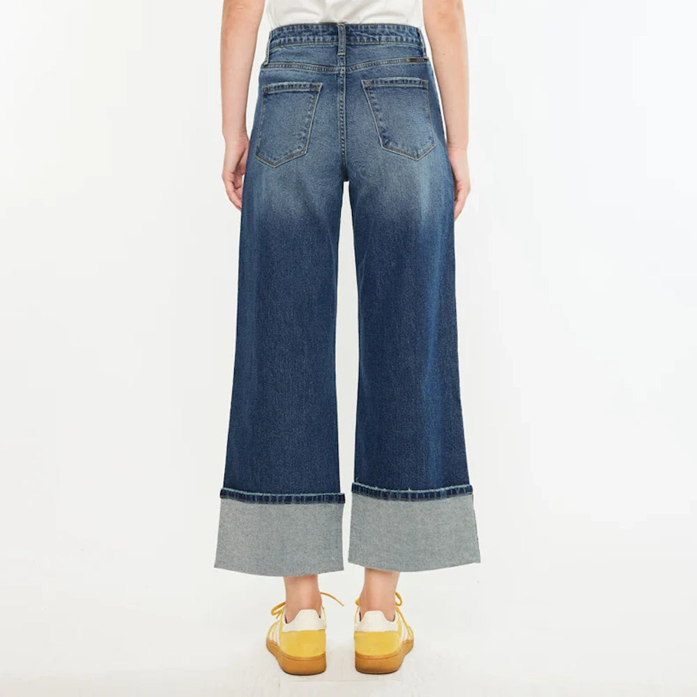 Back view of high-rise wide-leg crop jeans with large folded cuffs and back pockets in a dark indigo wash.