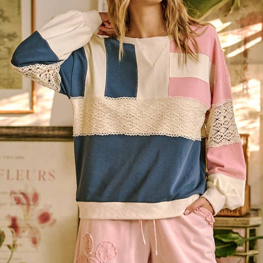 Oversized color-block sweatshirt in blue, pink, and cream with horizontal lace crochet detailing.