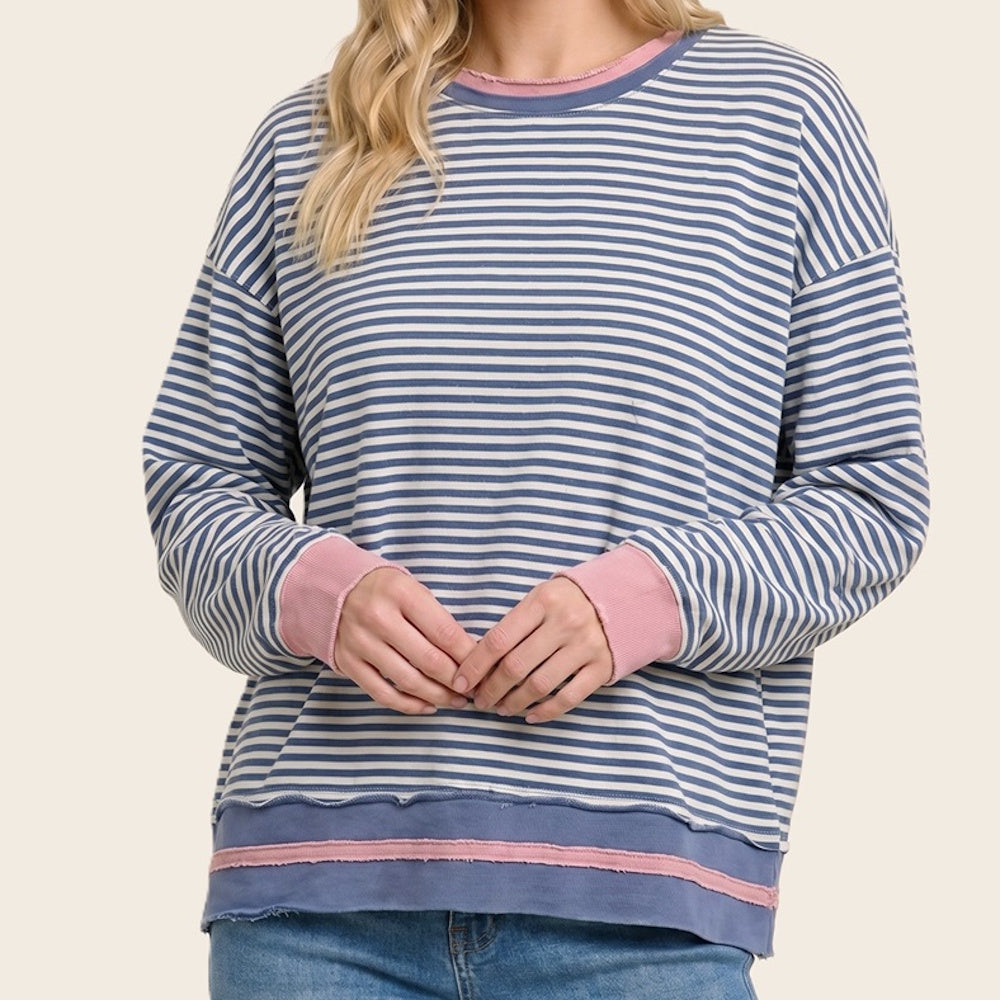 Front view of a blue and white striped cotton sweatshirt with pink contrast cuffs and hem.