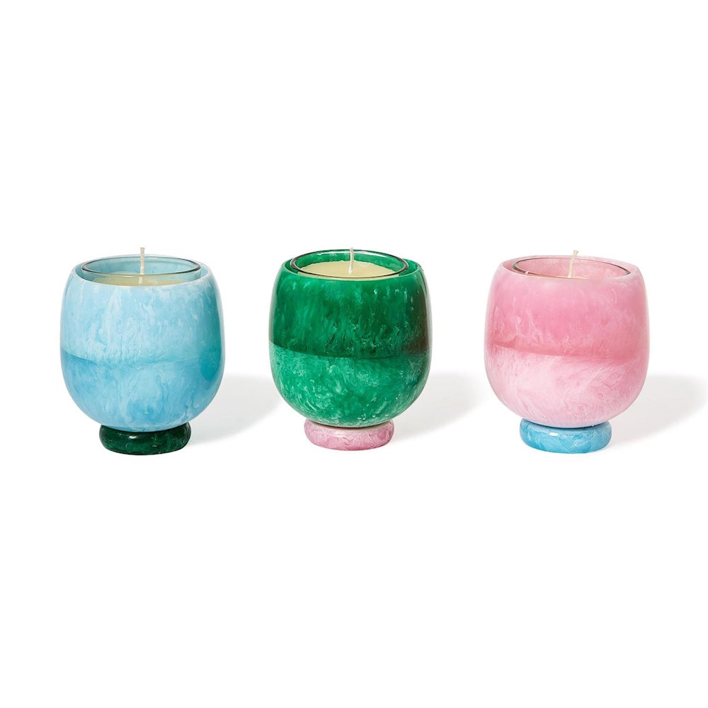 Three colorful swirl pedestal candle cups in blue, green, and pink with scented candles.