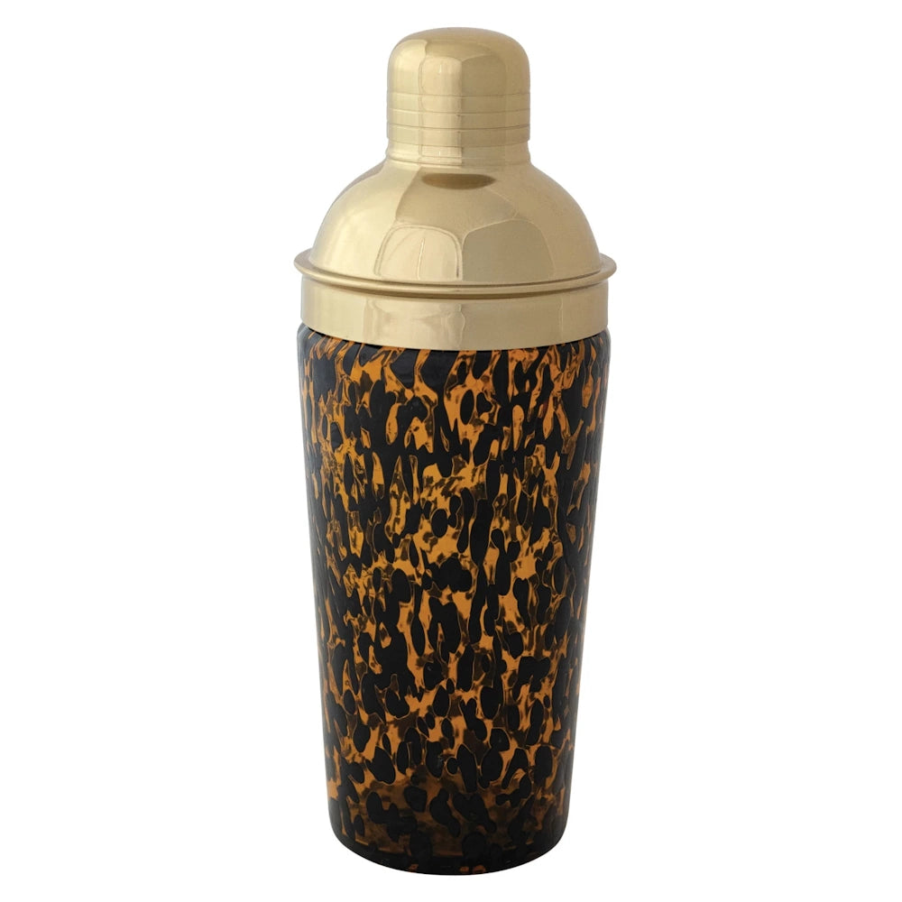 Tortoise shell pattern glass cocktail shaker with a polished gold-tone metal lid and cap on a white background.