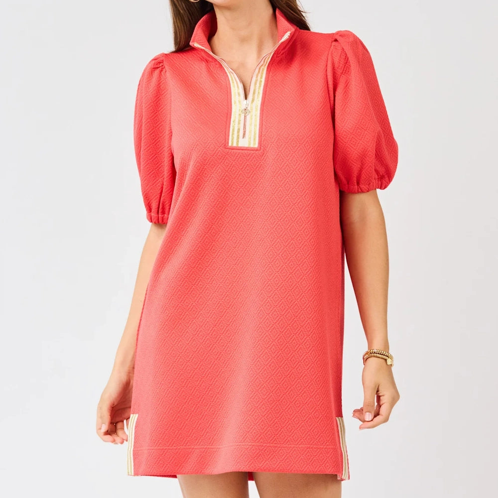 Coral puff sleeve shift dress in textured salmon pink with a gold-striped quarter-zip neckline and side slits.