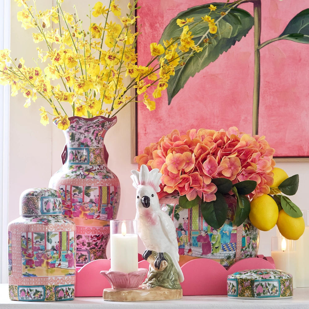 Gemini said
Colorful Chinoiserie vases with yellow orchids and coral hydrangeas next to a white cockatoo figurine and lemons.