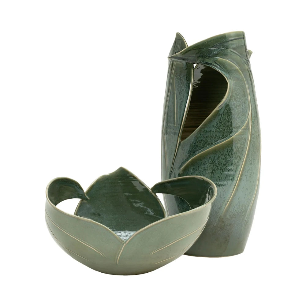 A set of two green ceramic items with leaf motifs, including a small bowl and a tall vase.