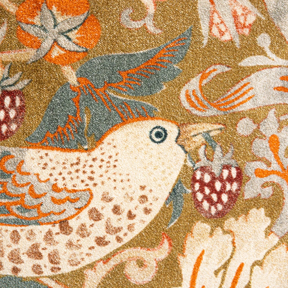 William Morris Strawberry Thief pattern rug detail featuring a bird with a strawberry on an olive green background.