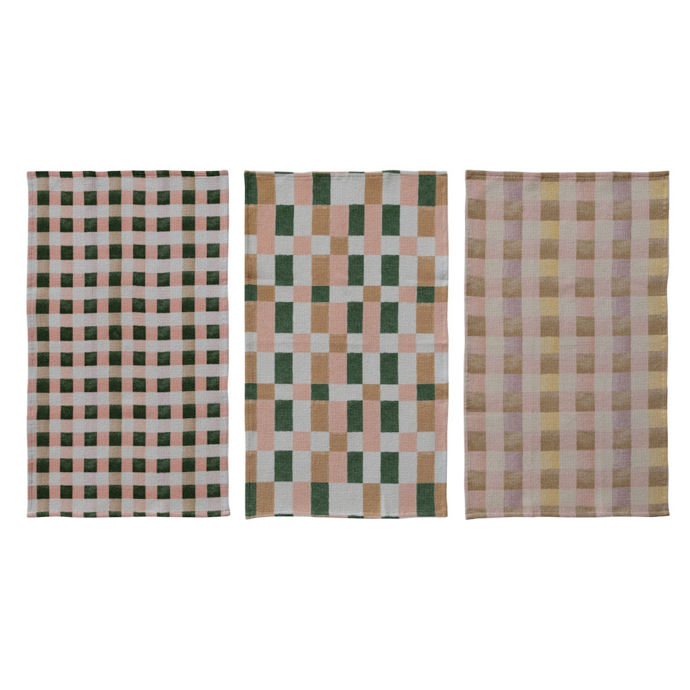 Set of three cotton blend waffle weave tea towels with green, pink, and tan plaid patterns for kitchen.
