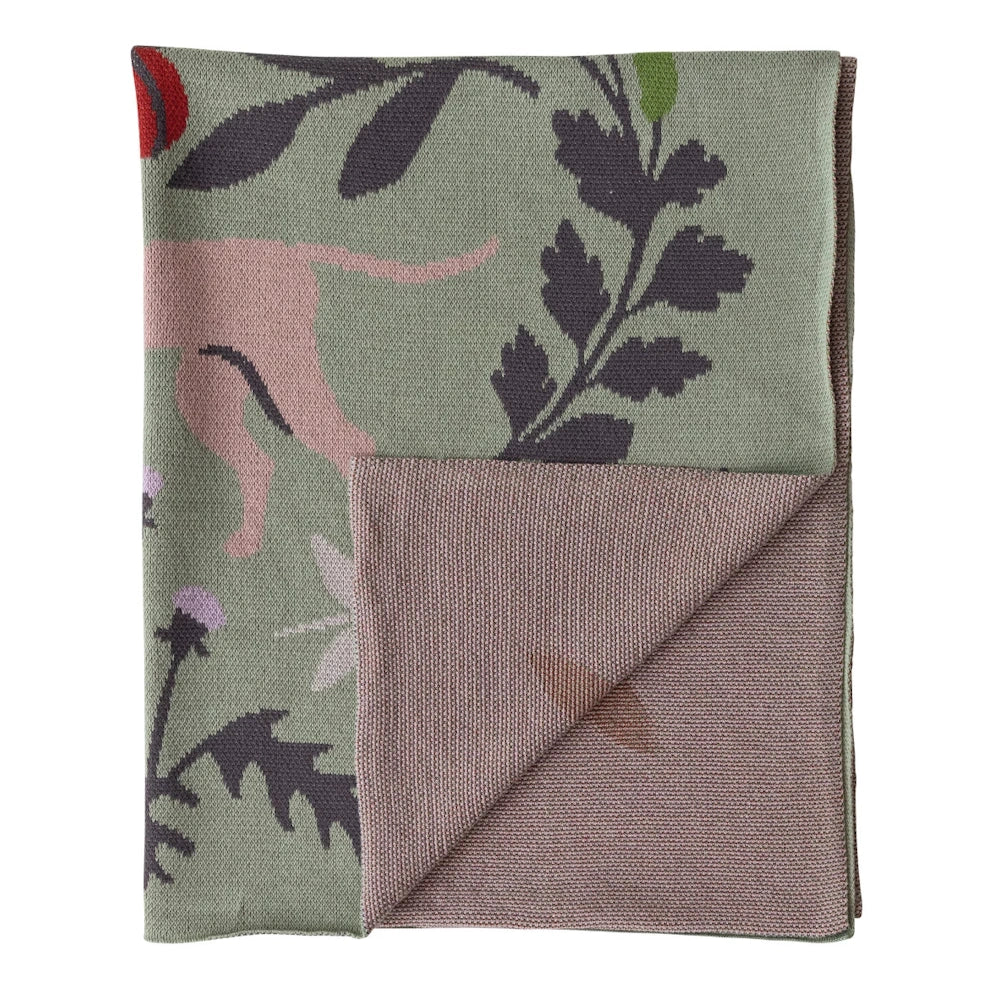 Green cotton knit baby blanket with pink animal and botanical leaf patterns.