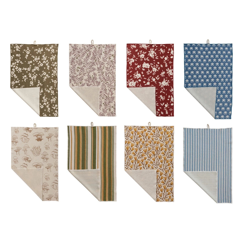Assortment of eight cotton terry cloth tea towels with floral, striped, mushroom, and leaf patterns in various colors.
