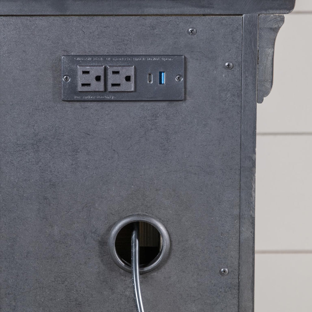 Close-up of a built-in power panel with two outlets, USB ports, and a cable management opening.