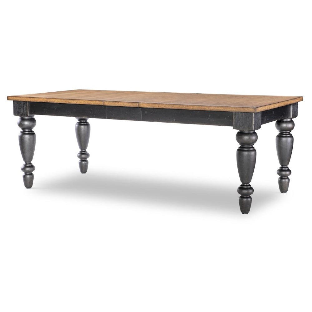 Rectangular dining table with natural wood top, black apron, and turned chimney-style legs angled view.