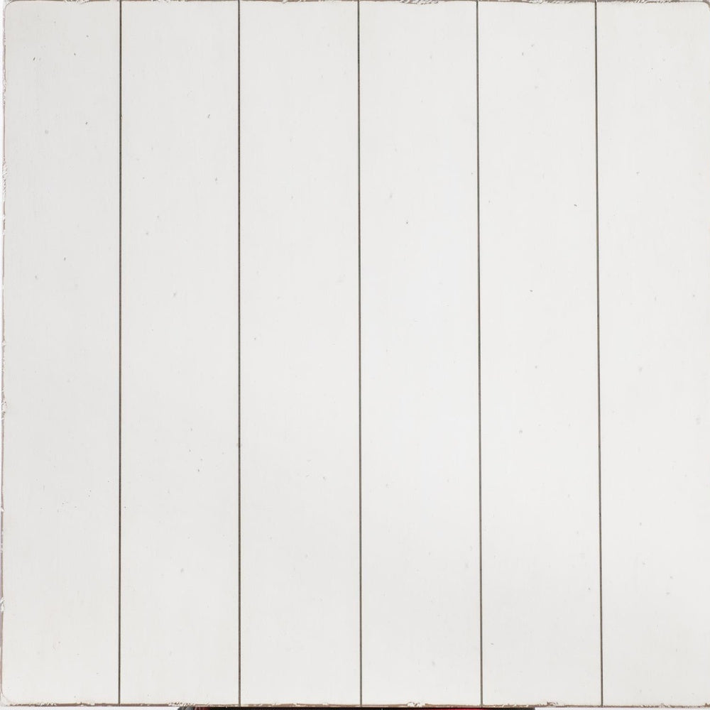 A close-up of white, vertically painted wooden panels with a slightly distressed texture.