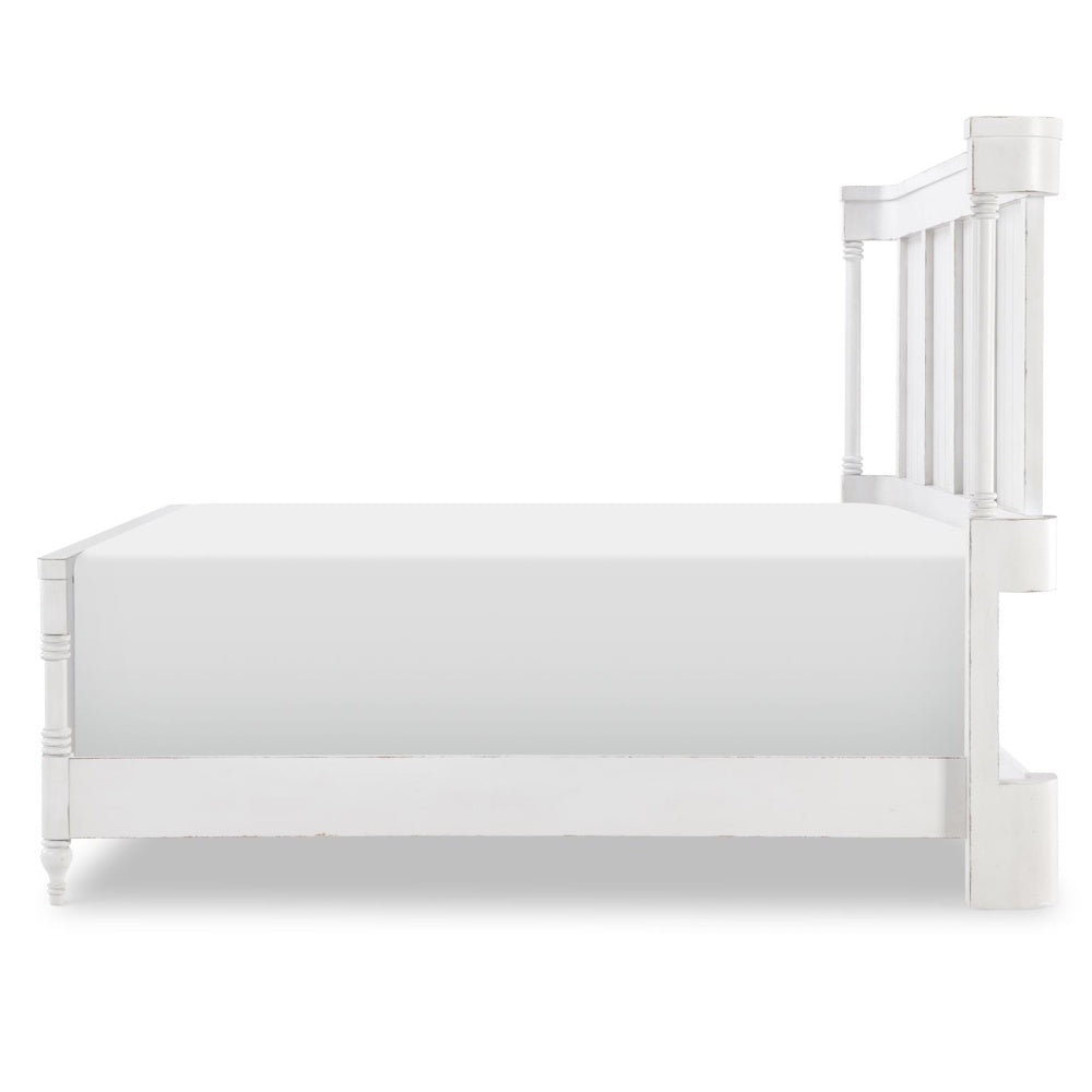 Side profile of a white wooden bed frame with a high headboard and plain white mattress.