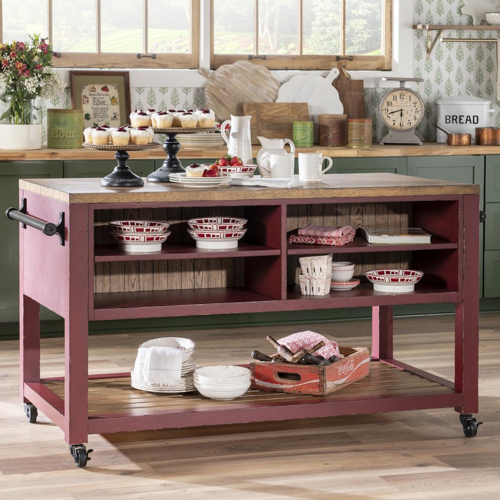 Rustic red rolling kitchen island with wood top, cupcakes, and farmhouse decor.
