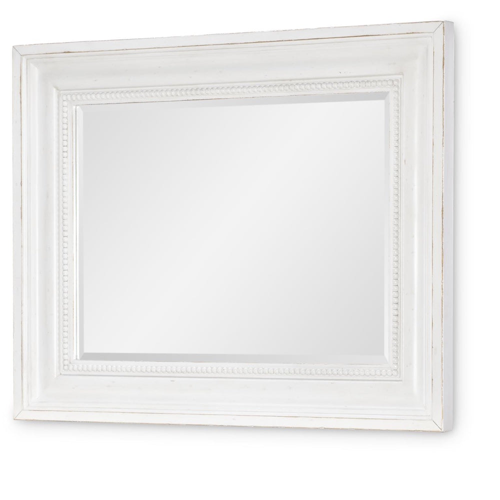 A rectangular mirror with a distressed white wooden frame featuring a beaded inner border.