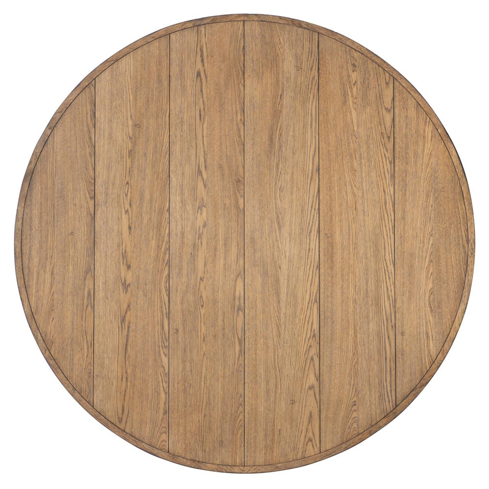Top view of a round light-brown wooden dining table surface showing vertical planks and natural grain.