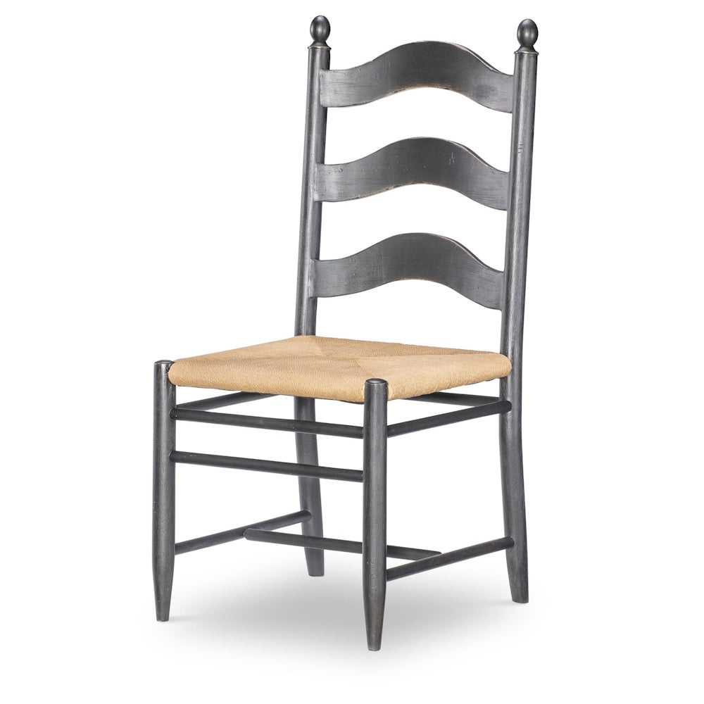 Gray ladder-back wooden side chair with woven rush seat and turned finials on top posts.