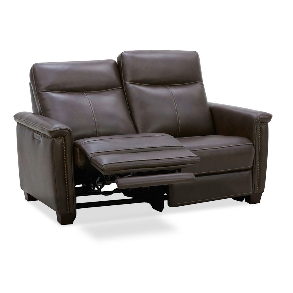 Modern brown leather power reclining loveseat with nailhead trim and footrest extended.