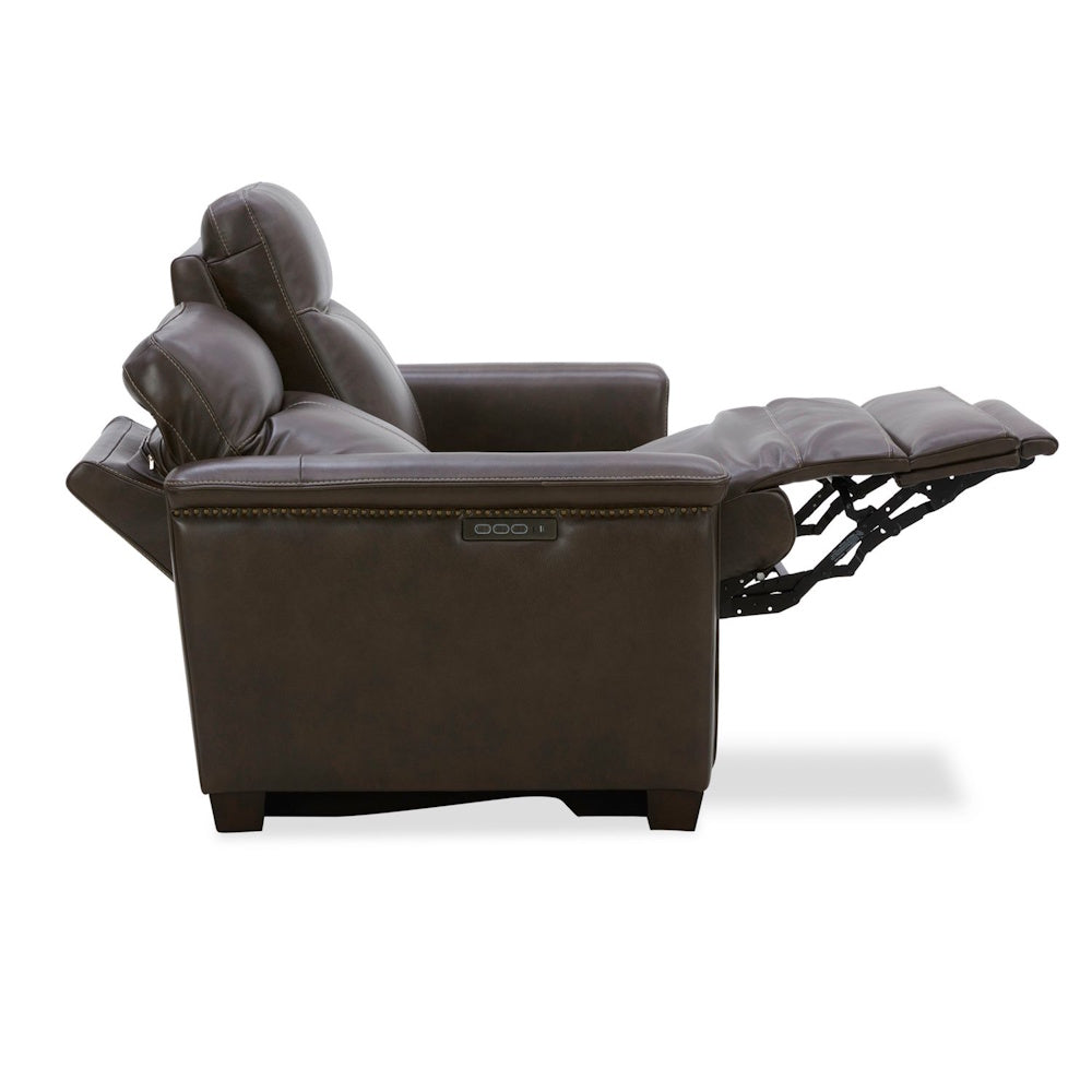 Brown leather power recliner armchair with adjustable headrest and footrest in reclined position.