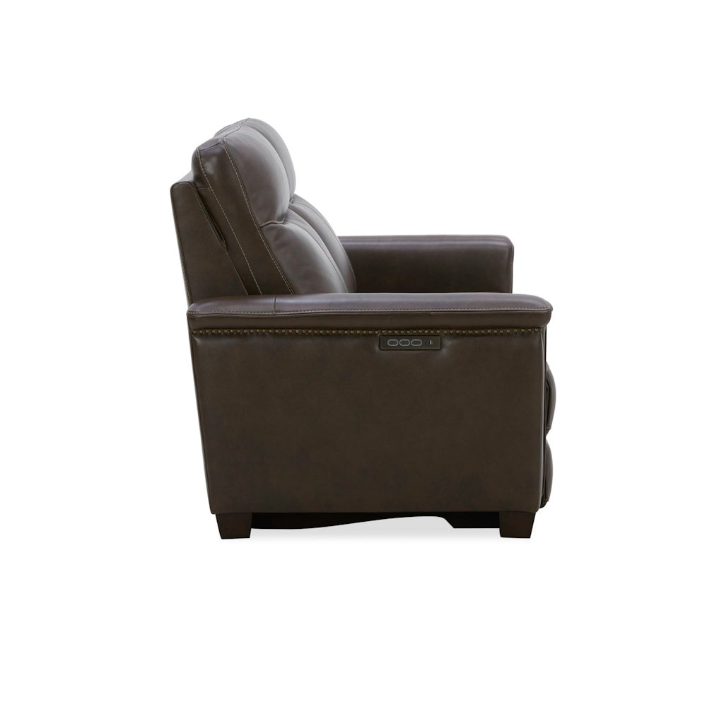 Brown leather power recliner armchair with nailhead trim and side controls.