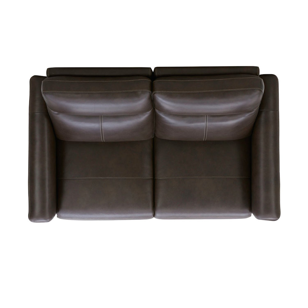 Top view of a modern dark brown leather loveseat sofa with two cushions on a white background.