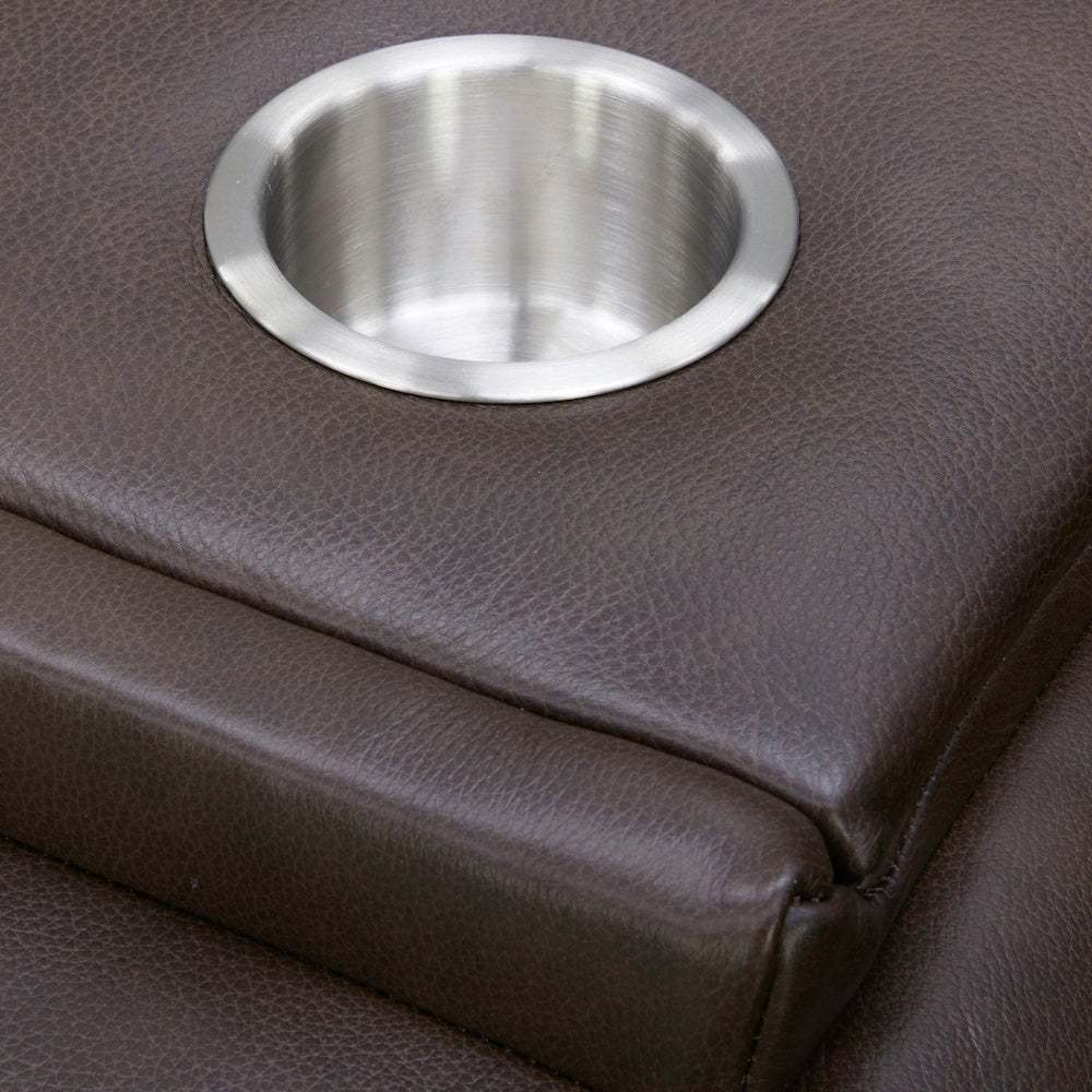 Stainless steel cup holder built into a brown faux leather sofa armrest.