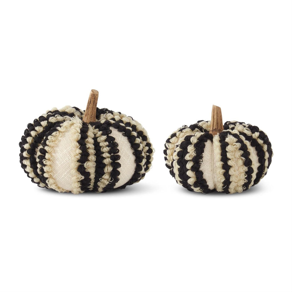 Two fabric decorative pumpkins with black and cream textured vertical stripes and small wooden stems.