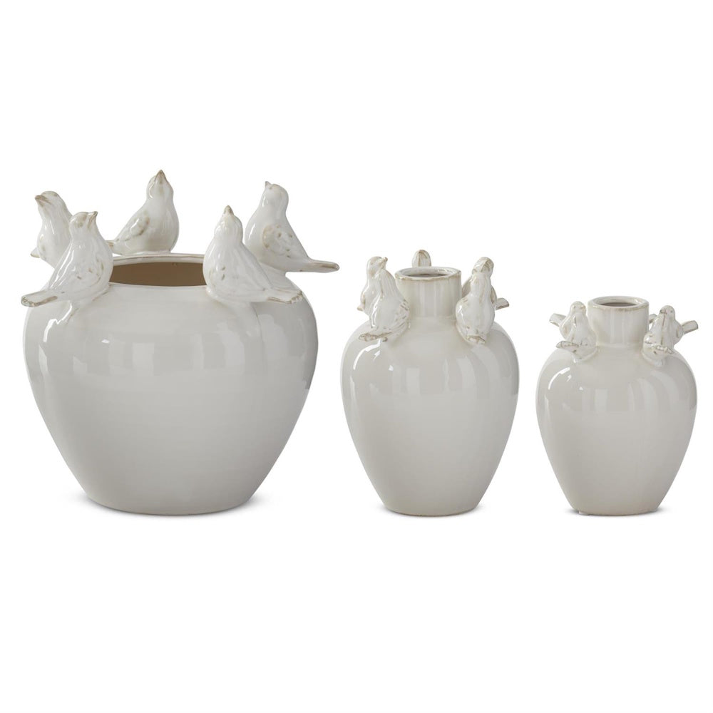 Three cream ceramic vases in varying sizes featuring sculpted bird figurines perched along the rims.