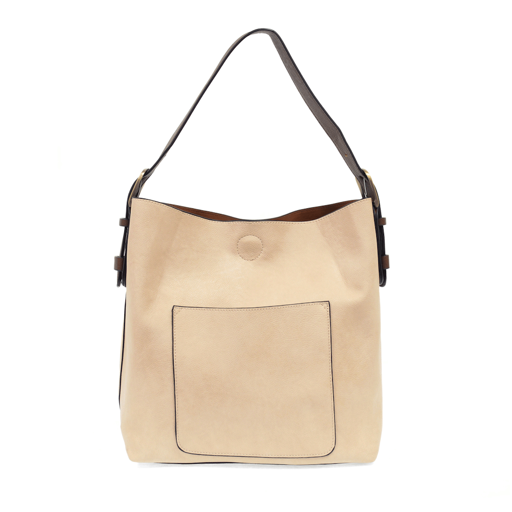 Cream-colored hobo shoulder bag with a brown handle and front pocket on a white background.